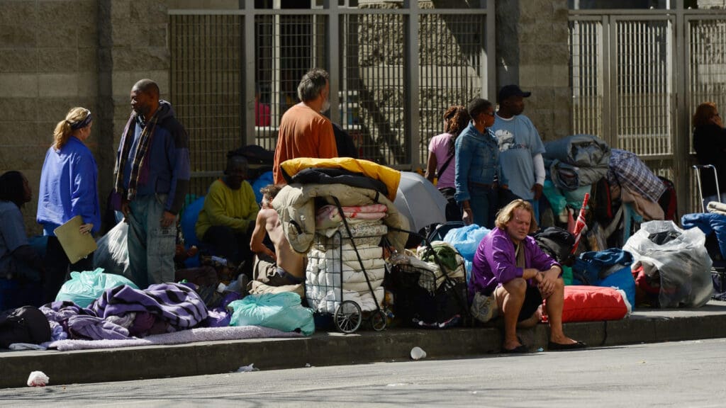 A homeless community on a city sidewalk.