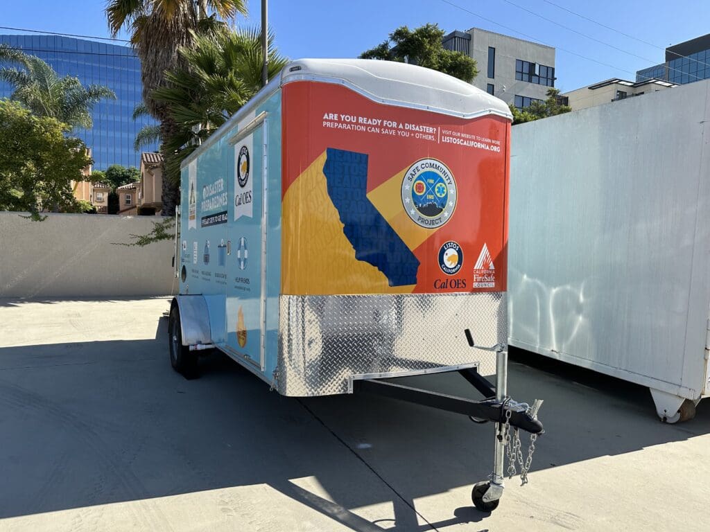 The side of a trailer marked with the logos of CalOES and the California Fire Safe Council.