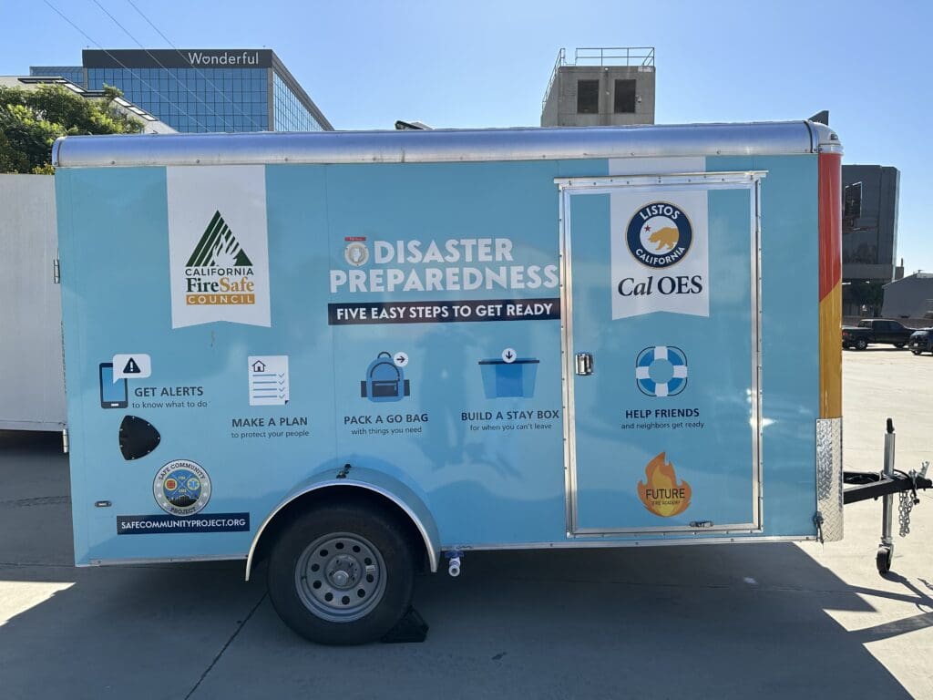 The side of a blue trailer marked with the logos of CalOES and the California Fire Safe Council.