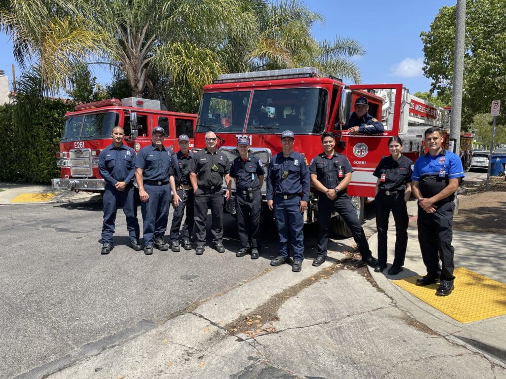 Members from the MySafe:LA team posing in front of a Los Angeles Fire Department fire engine.